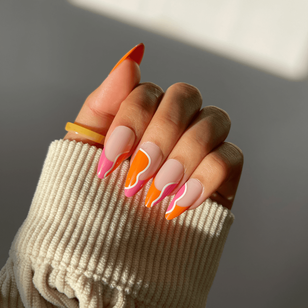 DANA almond-shaped press-on nails in orange and coral hues.