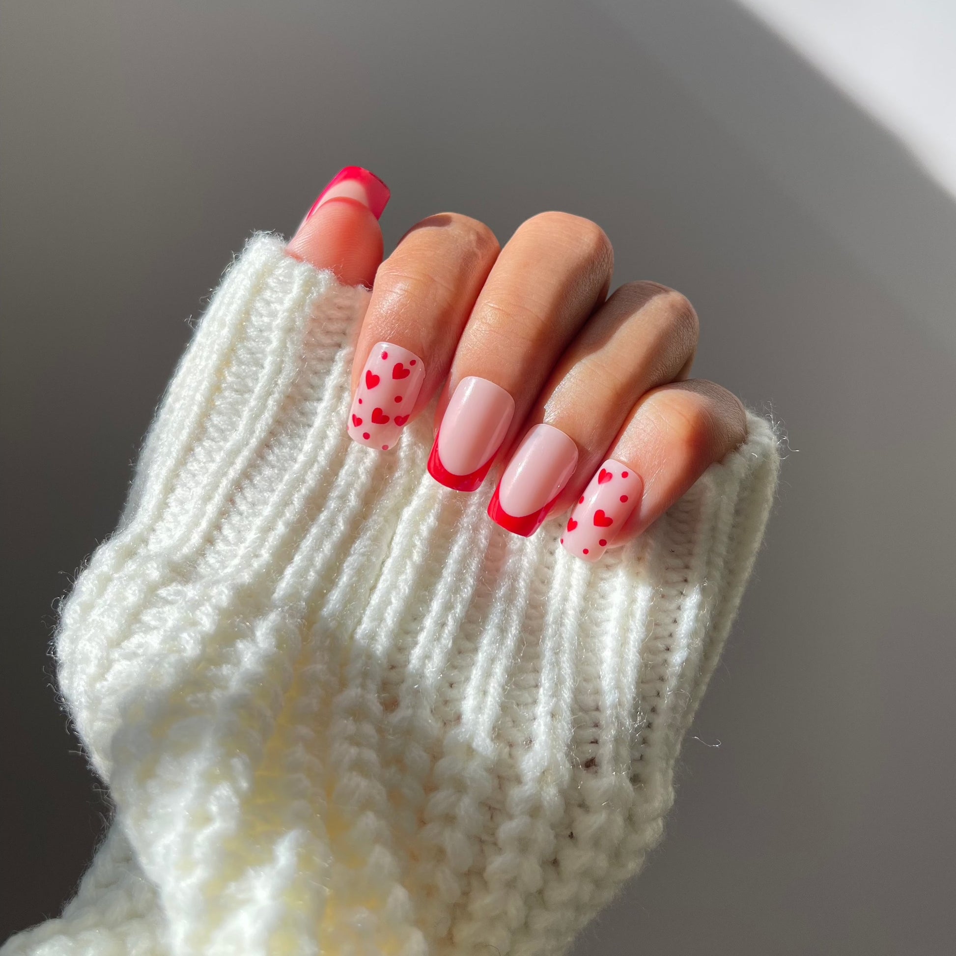 Esme press-on nails with red French tips and heart accents