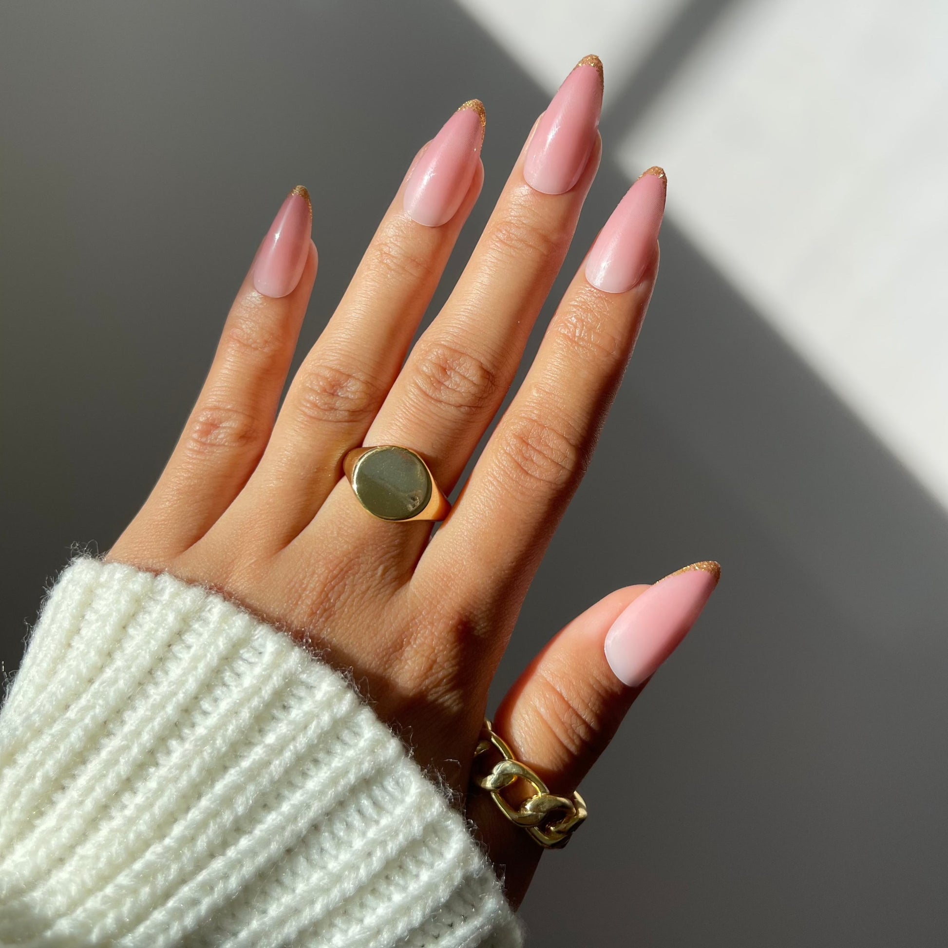 Rosie rosy ombre nails on hand with gold rings