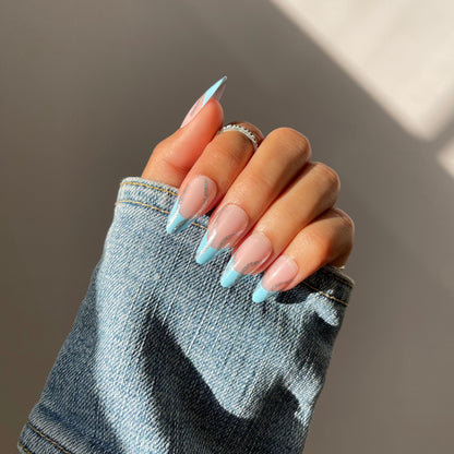 Hand with SKYE sky blue almond press-on nails