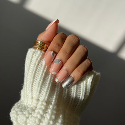 Close-up of Celine French tip press-on nails with silver glitter