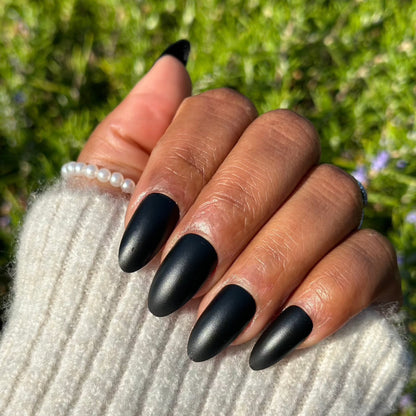 Black almond press-on nails in sunlight