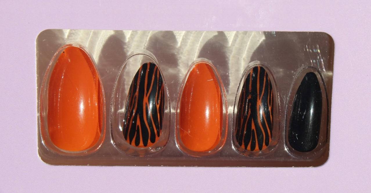 Set of Halloween press-on nails in orange, black, and zebra stripes