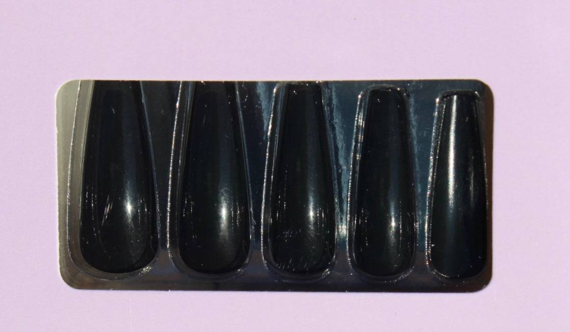 Close-up of glossy black press-on nails set