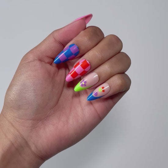 Multi-colored press-on nails for a fun summer look